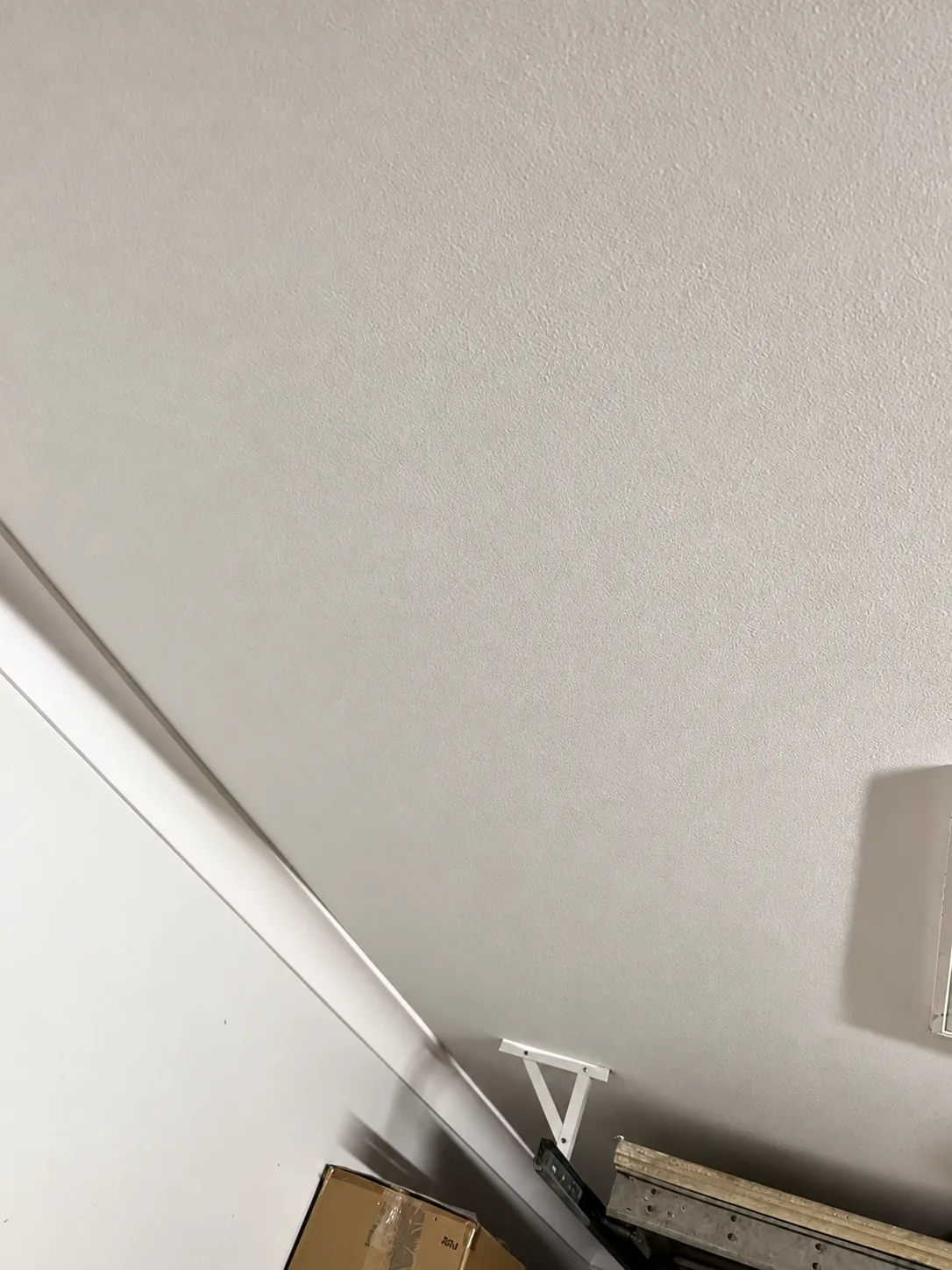 Possible repaired utility-room ceiling finish based on the stain photo