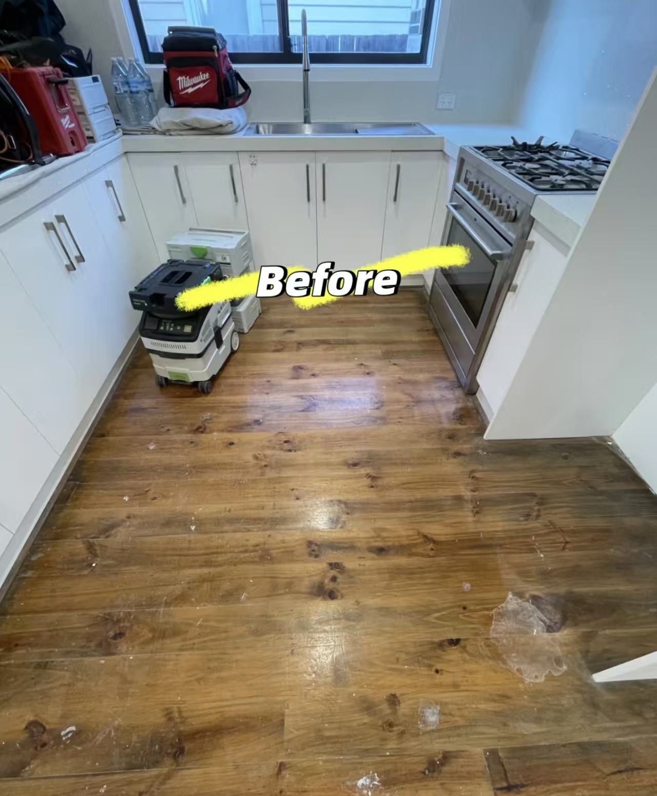 Dark timber floor in a kitchen before work