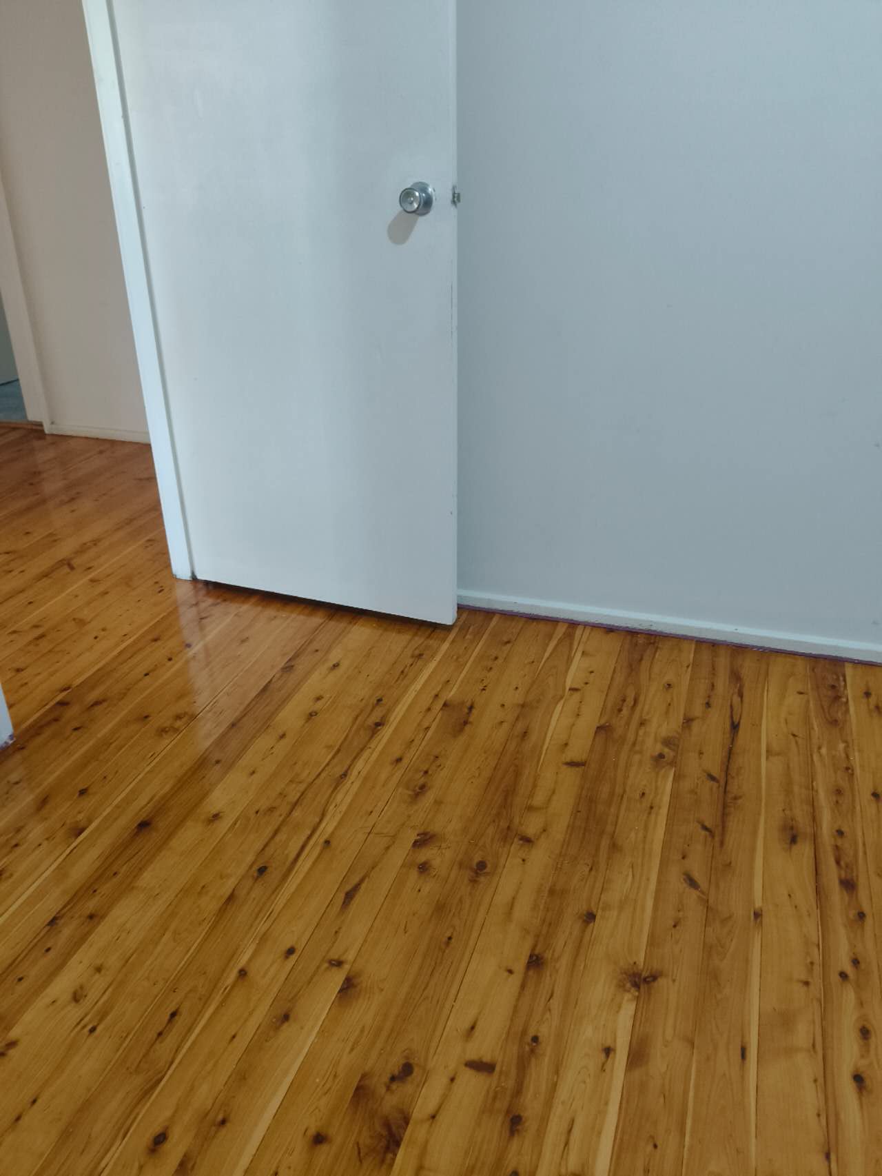 Timber flooring beside an interior doorway