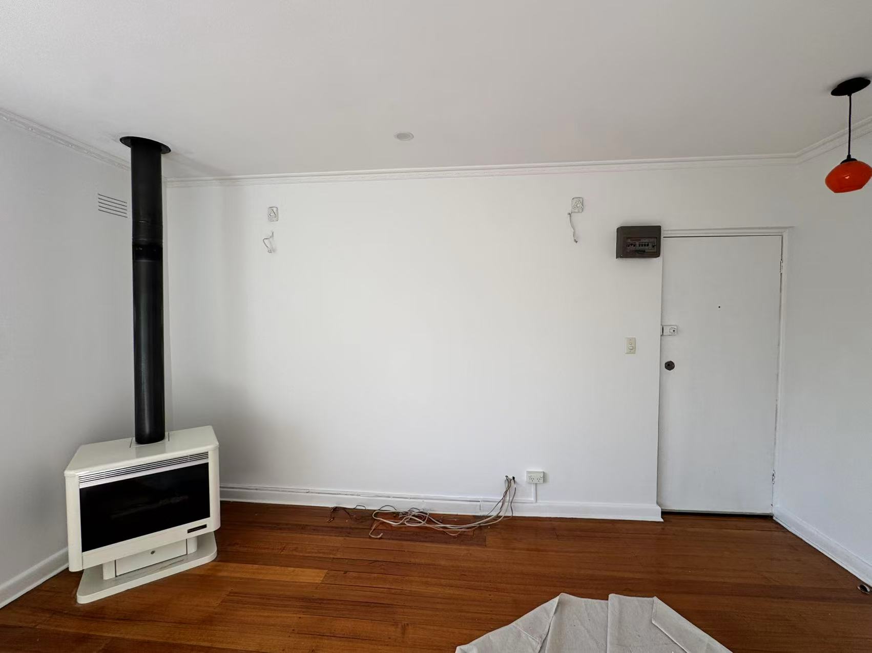 Light living room walls, interior door and timber flooring