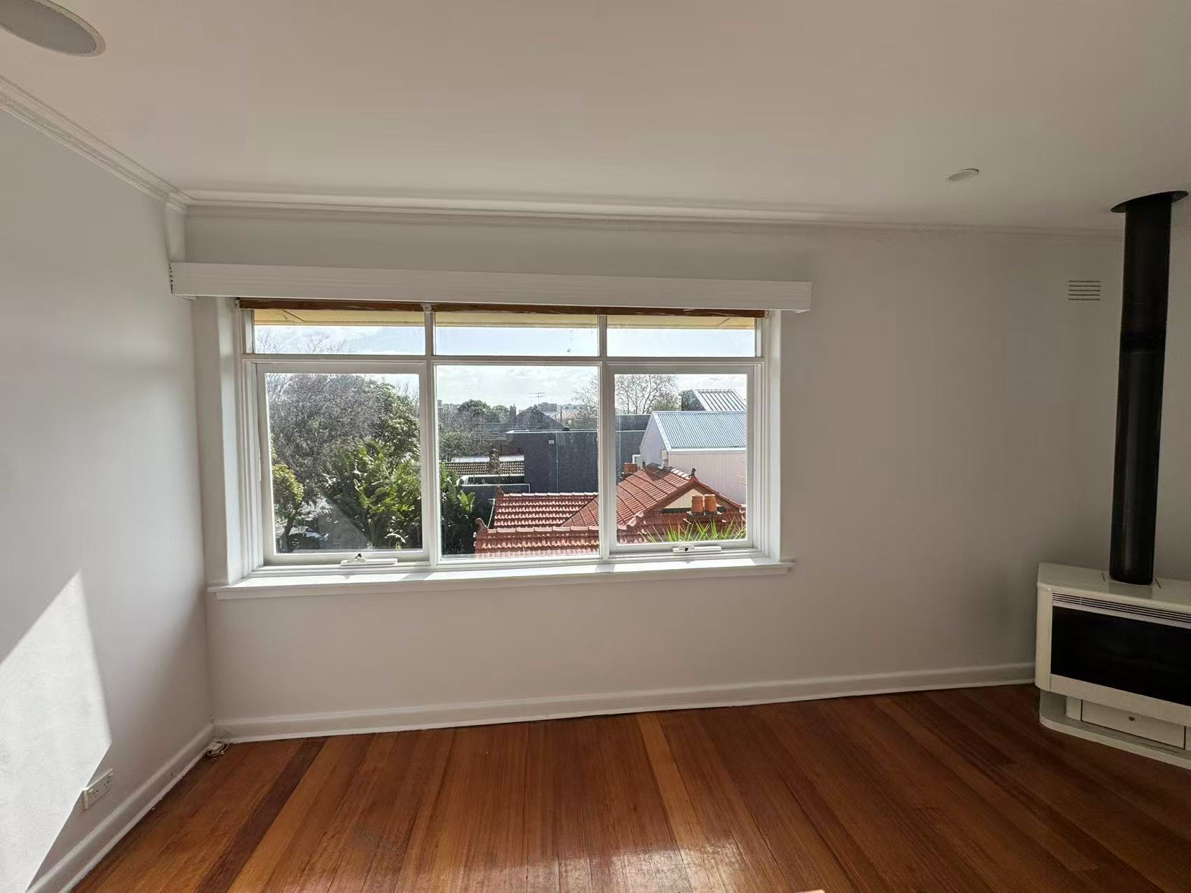 Light living room walls, windows and timber flooring